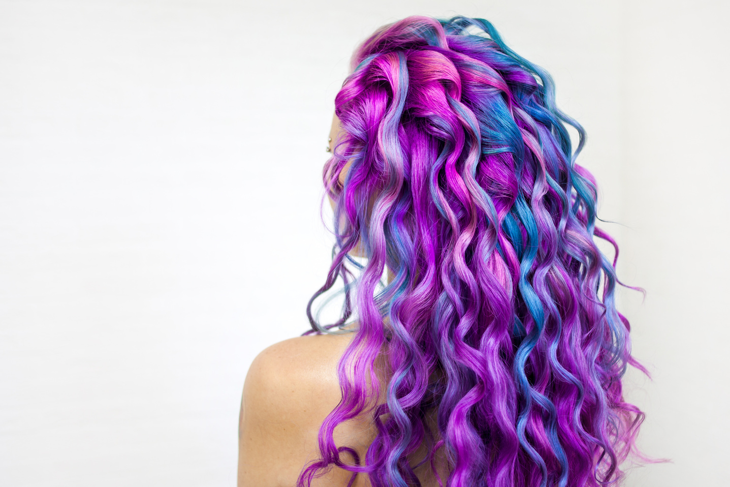 Bright multi-colored hair coloring, gradient blue purple and pink shades. Beautiful hair